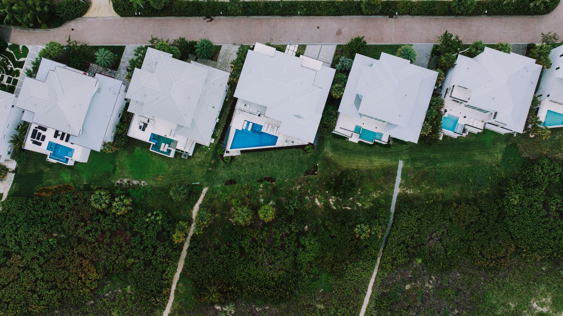 Aerial view of Port St Lucie area homes with backyard pools, the kind of properties that need steady home pool maintenance in Florida's climate.